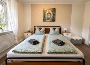 a bedroom with two beds with towels on them at Lütte Butze in Marne