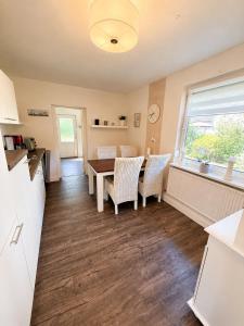 a kitchen and dining room with a table and chairs at Lütte Butze in Marne +16 photos