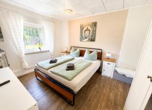 a bedroom with a bed and a window at Lütte Butze in Marne