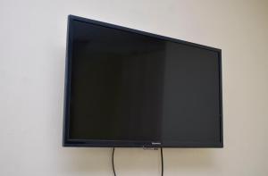 a flat screen tv sitting on a wall at Delfirm Hotel in Nairobi
