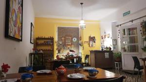 a dining room with a table and chairs and a room with at LosCardones in Cafayate