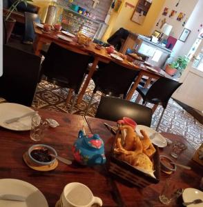 a wooden table with a plate of food on it at LosCardones in Cafayate +25 photos