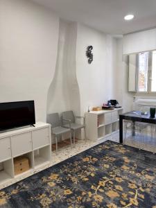a living room with a flat screen tv and a table at La Casa di Peppe in Rieti