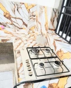 a stove top oven sitting on top of a counter at Paragone Home Stay Modern 3BR Apartment Style Home AC 5 Min to Enderamulla Station 15 Minute Train Ride to Colombo in Wattala