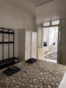 a bedroom with a bed with two black towels on it at La Casa di Peppe in Rieti