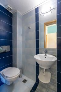 a bathroom with a toilet and a sink at Cristels Studios 1 in Skala Marion