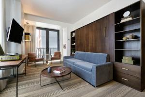 a living room with a blue couch and a table at Halcyon, a hotel in Cherry Creek, Denver in Denver