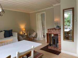 a living room with a couch and a fireplace at 6 person holiday home in 38472-By Traum in Tillingenabben
