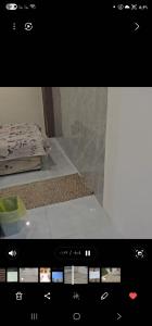 a view of a tv screen with a bed in a room at شقة بحوش خاص in Al Baha +14 photos