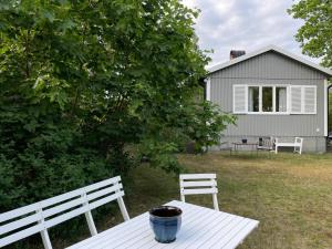 a white picnic table with a pot on it next to a house at 6 person holiday home in 38472-By Traum in Tillingenabben