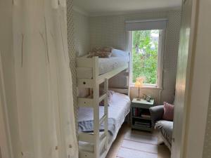 a small bedroom with a bunk bed and a window at 6 person holiday home in 38472-By Traum in Tillingenabben