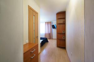 a room with a bedroom with a bed and a dresser at PaulMarie Apartments on Parijskoi Kommuny in Gomel