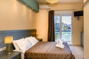 a bedroom with a bed with a view of the water at Cristels Studios 1 in Skala Marion