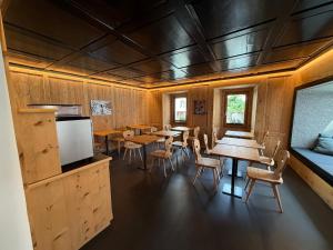 a dining room with wooden walls and tables and chairs at Pensiunina - Pension - Sent in Sent