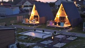 two yurt homes with a pool in the yard at Lodge Lady Tipi 2 avec jacuzzi et piscine in Saint-Utin