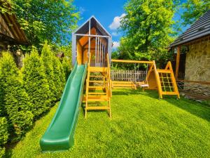 a playground with a slide in a yard at Drevenička Zázrivá Terchová in Zázrivá