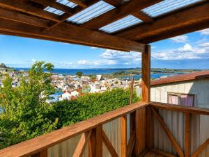 a balcony with a view of a town at El Urco Chiloé - Hostal y Cabaña in Ancud