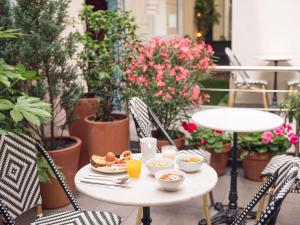 a table with food and drinks on a patio at Ibis Styles Paris Batignolles in Paris