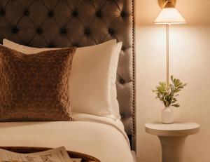 a bedroom with a bed with a pillow and a lamp at Ceros in Denver