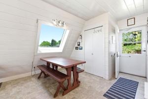 a bathroom with a wooden table and a window at Chalet #20 in Stevensville