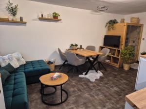 a living room with a couch and a table at Apartmán U Lanovky in Kramolín