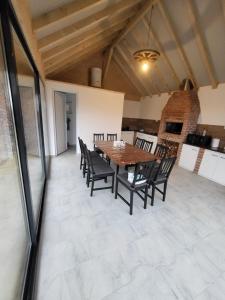 a dining room with a wooden table and chairs at Cabana Andi in Brebu +20 photos