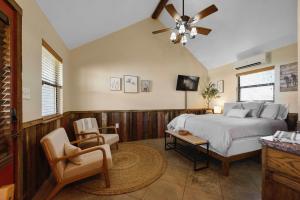 a bedroom with a bed and a ceiling fan at Nicole Creek Cabins in Waco