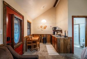 a kitchen with a wooden table and a dining room at Nicole Creek Cabins in Waco
