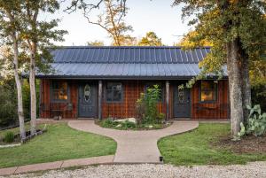 a house with a walkway in front of it at Nicole Creek Cabins in Waco