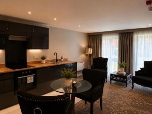 a kitchen and living room with a table and chairs at Primrose Manor in Risley