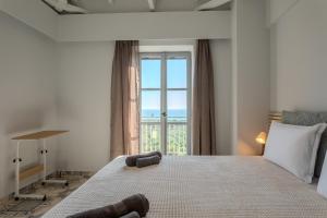 a bedroom with a large bed with a large window at Aether Blue Eco Villas in Agios Nikolaos +56 photos