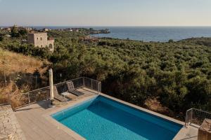 a swimming pool with a view of the ocean at Aether Blue Eco Villas in Agios Nikolaos