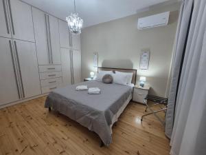 a bedroom with a bed with two towels on it at Salve Suite in Lefkada