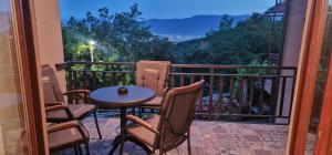 a balcony with a table and chairs and a view at Panorama house in Sarajevo