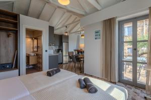 a bedroom with a large bed with two pillows on it at Aether Blue Eco Villas in Agios Nikolaos