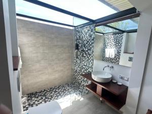 a bathroom with a sink and a shower at BlackRoots Unawatuna in Unawatuna +57 photos