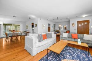 a living room with two couches and a table at Relaxing Barnstable Getaway Close to the Beach in Barnstable