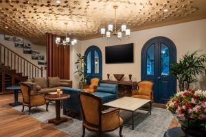 a living room with blue furniture and a tv at Holiday Inn Express Quito by IHG in Quito