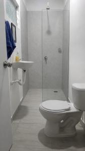 a bathroom with a shower and a toilet and a sink at Casa Almarita Hostel Social Bar in Medellín +13 photos