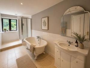 a bathroom with a tub and a sink at Primrose Manor in Risley +44 photos