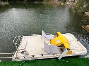 a boat with a yellow engine on the water at Leo Green House in Cinciş