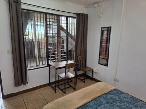 a bedroom with a bed and a window with a staircase at Luca in San José