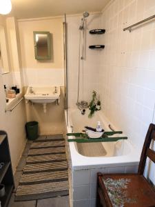 a bathroom with a tub and a sink at The Big Tree Cottage in Graafwater +42 photos