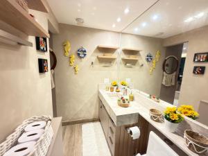 a bathroom with a sink and a mirror at Marulhos resort Muro Alto flats Premium frente ao mar in Porto De Galinhas