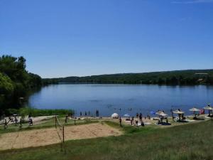 a group of people on a beach near a lake at Camp Kalinovac in Zatonje +16 photos