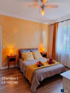 a bedroom with a bed with two pillows on it at La Note Verte - Parking gratuit devant l'entrée in Foix
