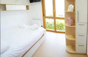 a bedroom with a white bed and a window at Welcome Villa O Sidrón in Alba +46 photos