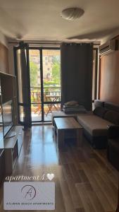 a living room with a couch and a table at Atliman Beach Apartment 1 in Kiten