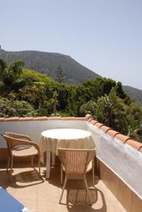 a table and chairs sitting on a balcony with a view at Apartamentos Finca Colon in Los Quemados
