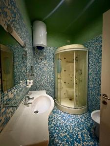 a bathroom with a sink and a glass shower at Diaz 10 Suite in Trieste